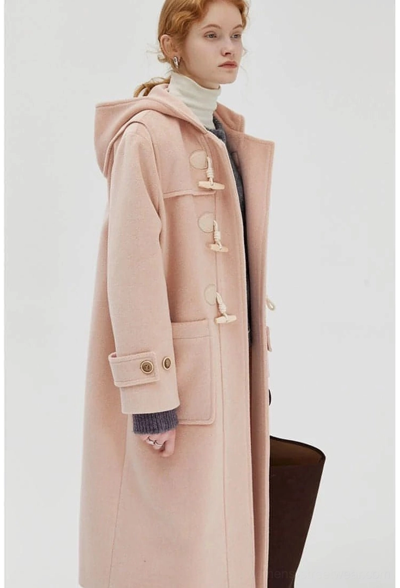 Duffle coat with oversized layering showing hood and pocket details on model