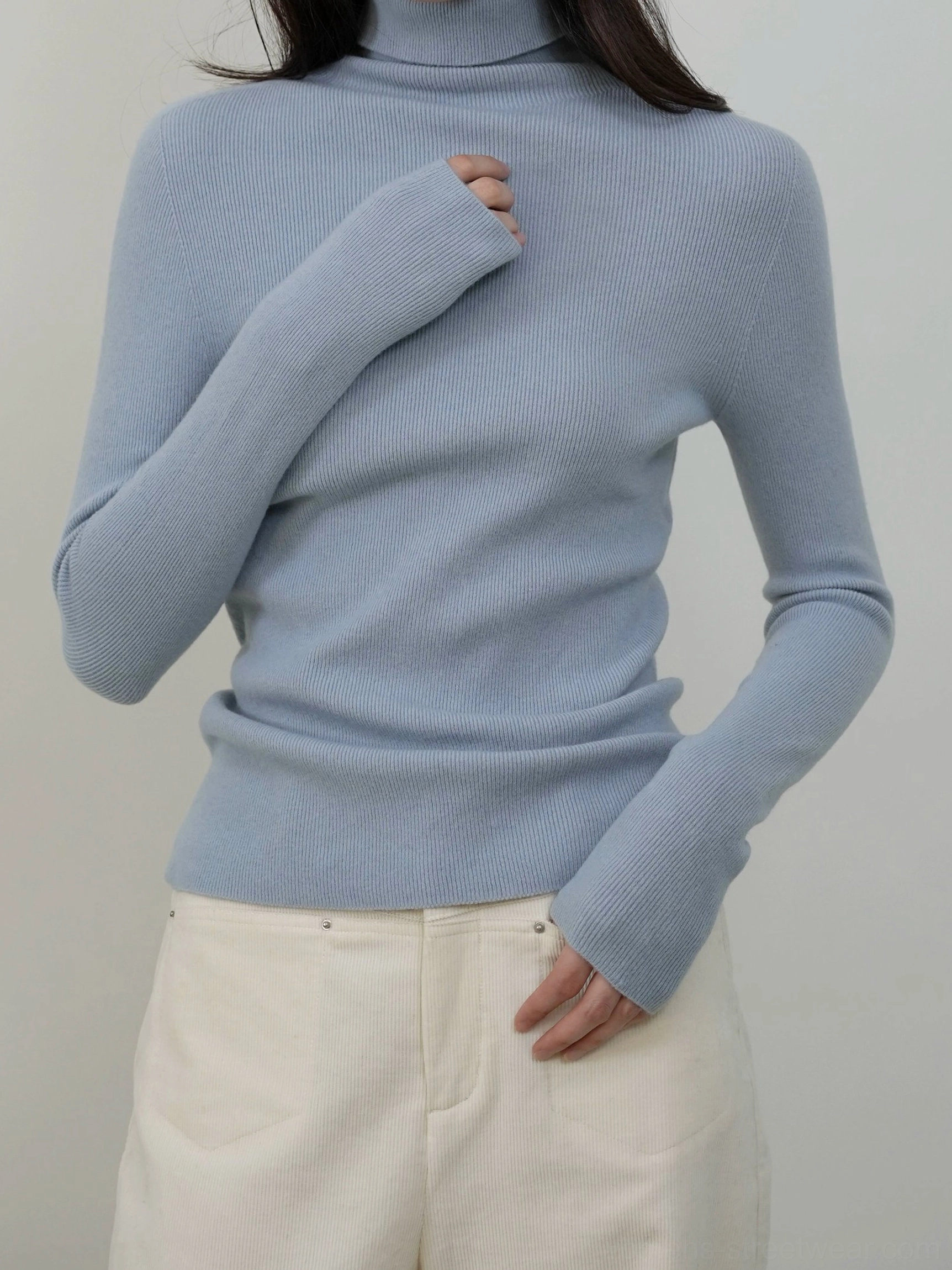 Dusty light blue ribbed mock neck knit sweater with extended long sleeves and a slim fitted shape