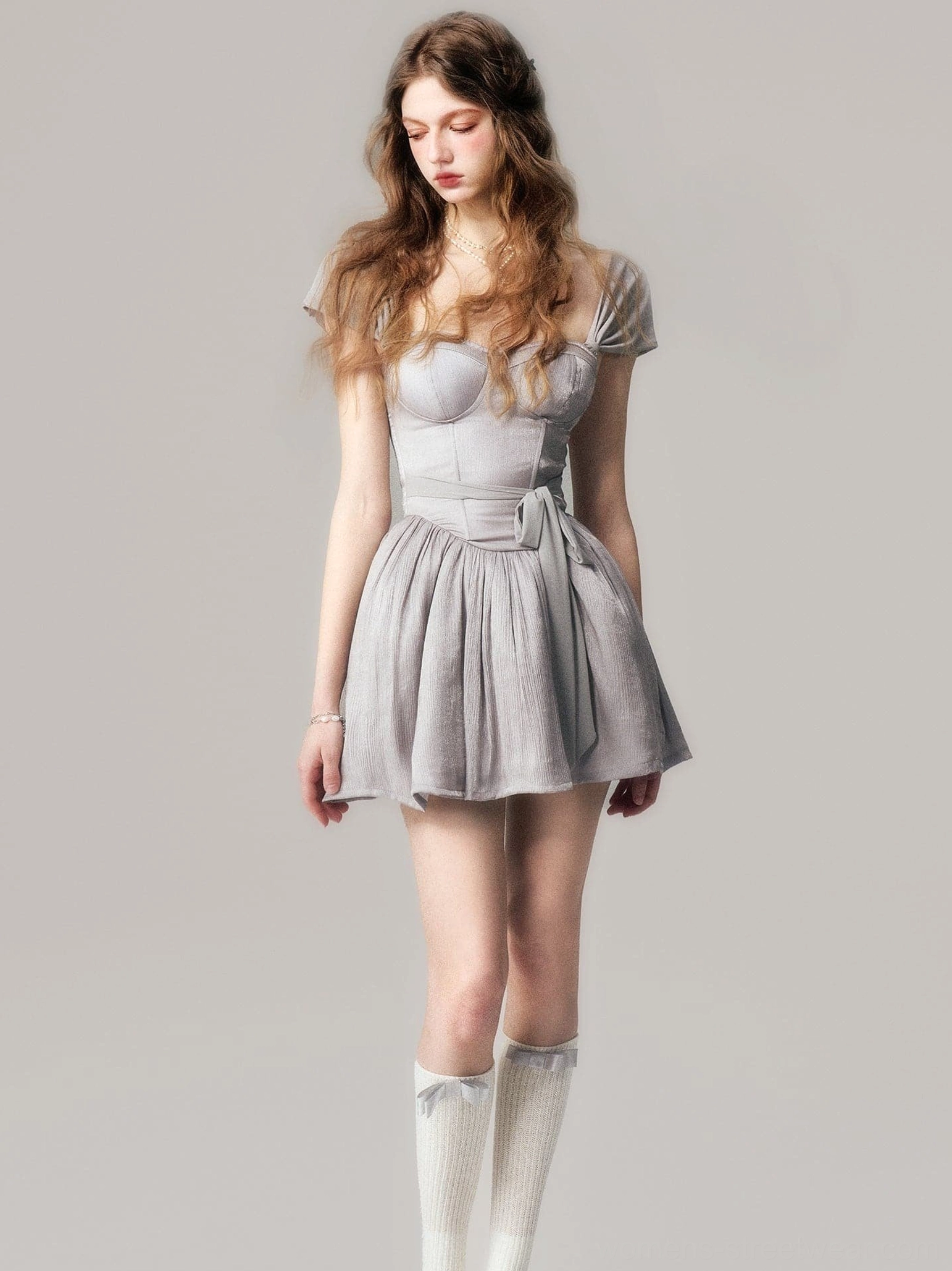 Dusty gray short sleeve tutu mini dress styled with white knee high socks and a tied waist bow