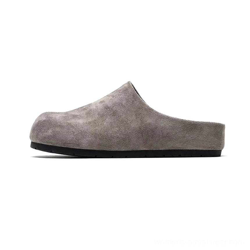 Dusty grey suede-effect closed-toe slip-on clog shown in side profile with rounded toe, open back, and minimalist black sole
