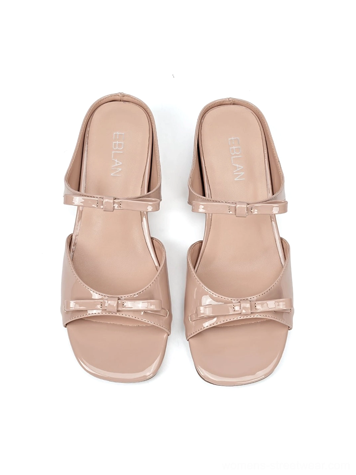 Pair of dusty pink bow wedge slide sandals shown from the front with matching bow straps and glossy open-toe design