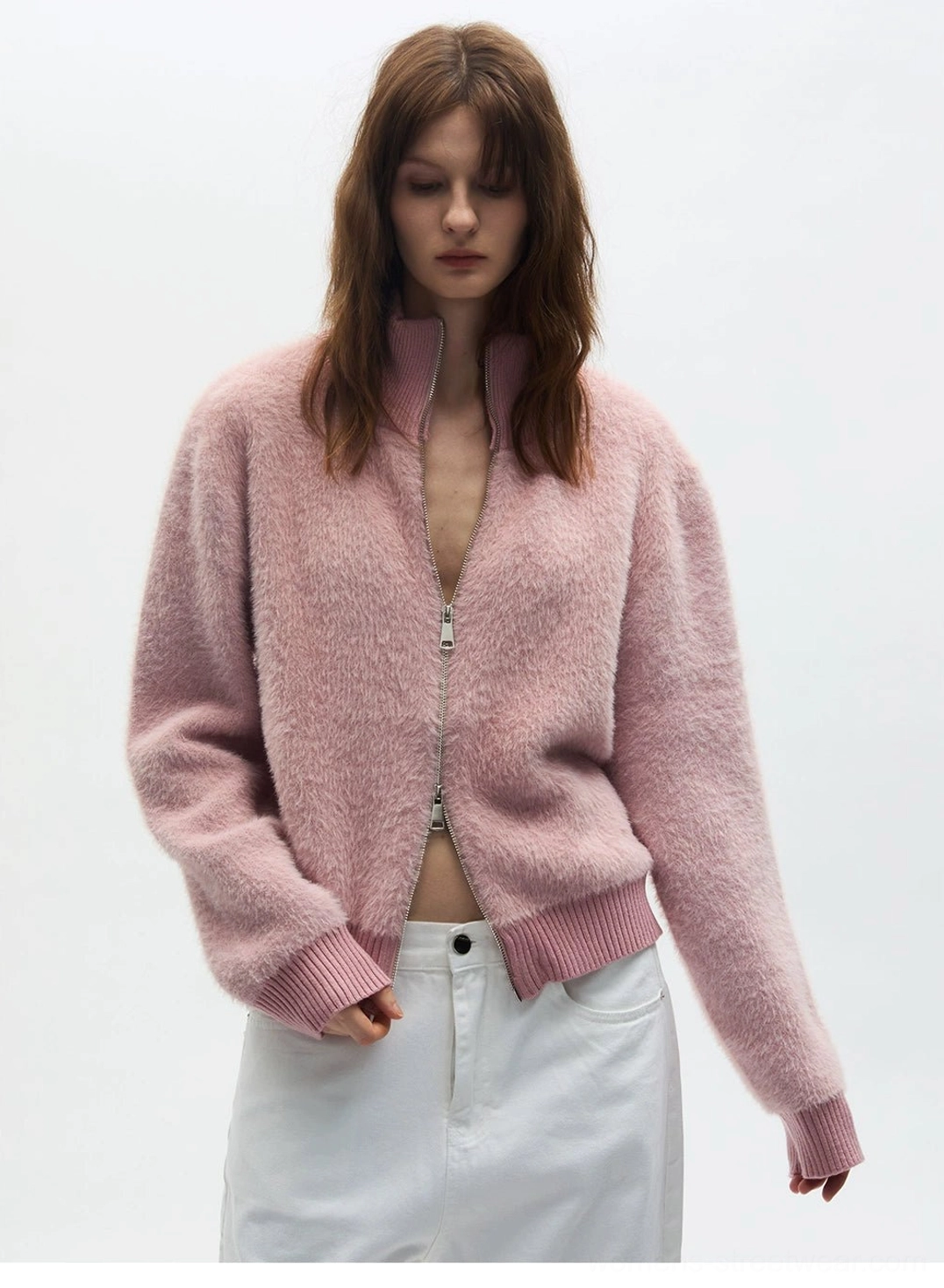 Close-up of dusty pink cropped fuzzy zip-up fleece cardigan with ribbed hem cuffs and stand collar