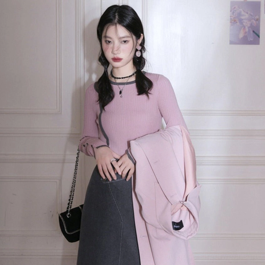 Dusty pink ribbed long sleeve knit top styled with dark gray midi skirt and light pink coat