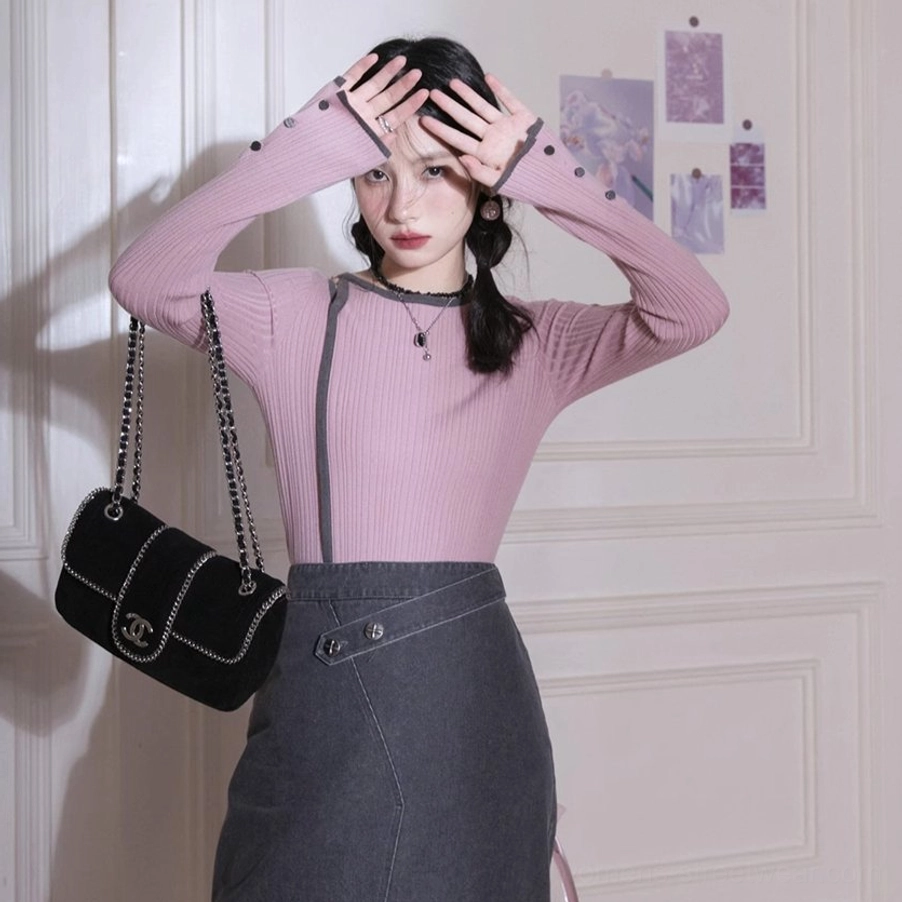 Dusty pink fitted ribbed knit shirt with dark gray neckline trim and long buttoned sleeves