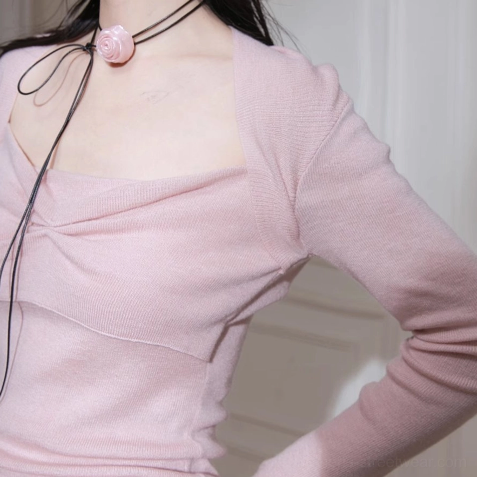 Feminine dusty pink knit streetwear top with twisted bust detail and versatile fitted silhouette