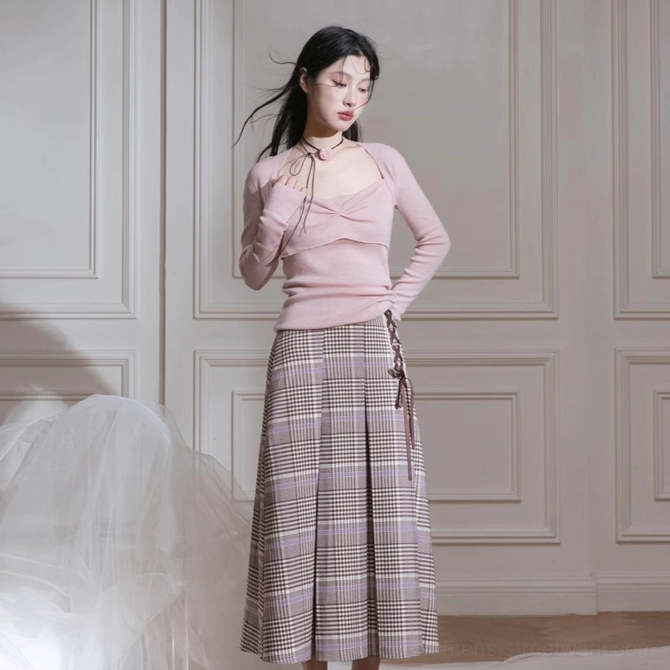 Back view of fitted dusty pink long sleeve knit top with waist skimming silhouette and plaid midi skirt