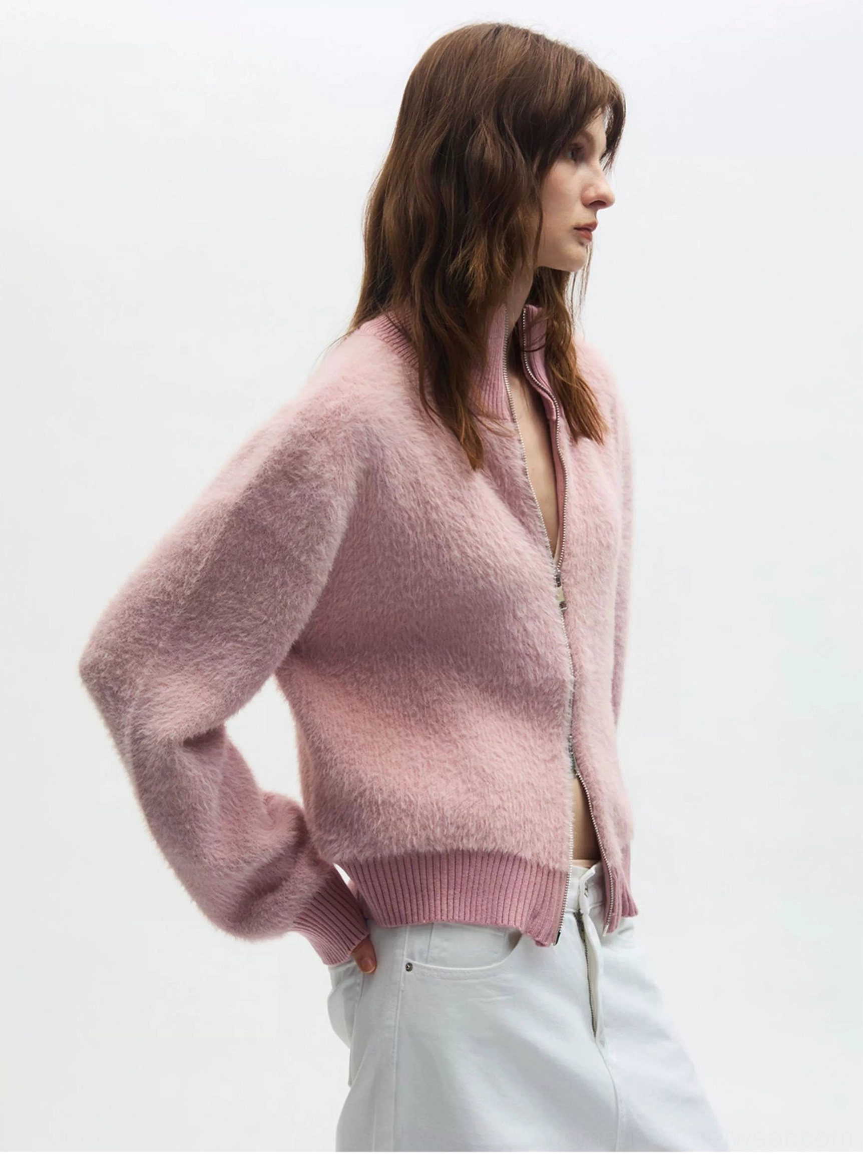Dusty pink plush zip-up fleece cardigan in three-quarter side view showing slim long sleeves and soft texture