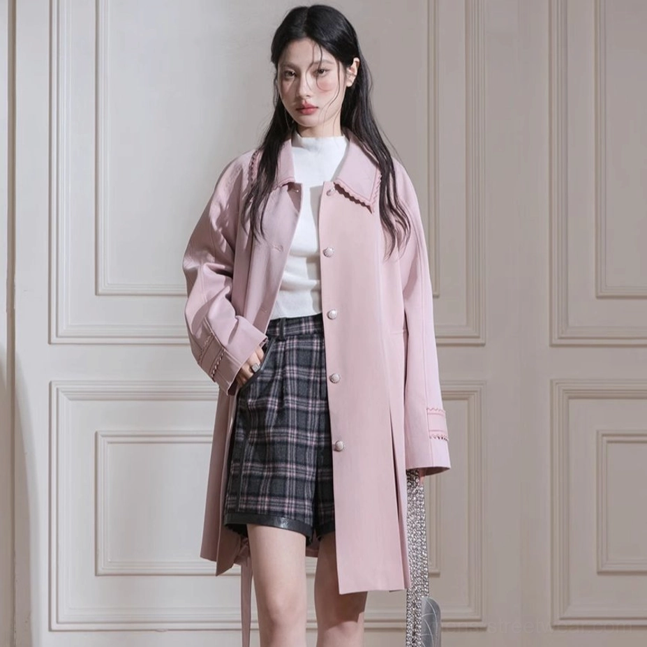 Full side view of dusty pink pleated hem trench coat showing side pocket scalloped collar and tailored fit