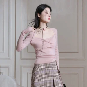 Korean inspired dusty pink twist front knit top worn with a plaid pleated midi skirt and rose choker