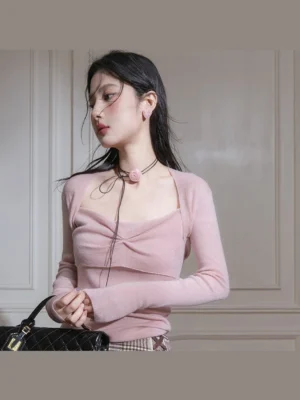 Dusty pink twist front ribbed knit top with square neckline and fitted long sleeves styled with checked bottoms