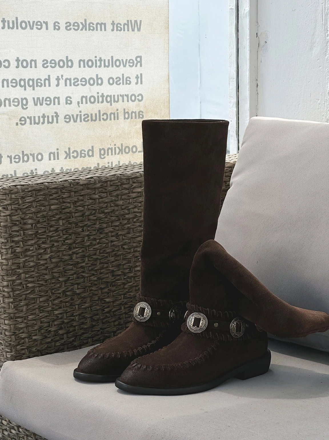 Earth-tone suede western knee-high riding boots for women with decorative buckles, moc-toe stitching, and casual low heels