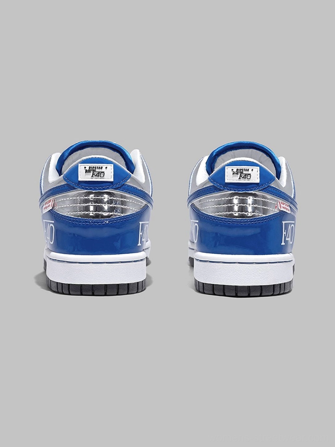 Rear view of electric blue retro platform sneakers featuring silver reflective heel panels, F40 graphic, and thick black rubber outsole