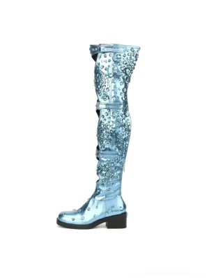 Single electric blue rhinestone-style over-the-knee boot with metallic finish, graphic cutout shaft, adjustable buckle straps, square toe, and block heel