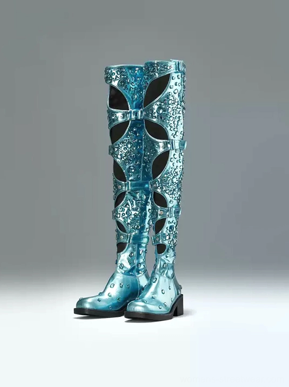 Front view of a pair of electric blue rhinestone-style over-the-knee boots with bow-shaped cutouts and adjustable buckles