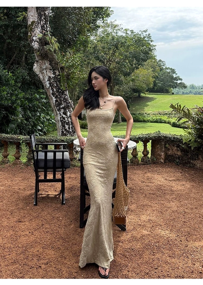 Elegant beige lace maxi dress designed with a sculpted mermaid cut delicate texture and versatile neutral color