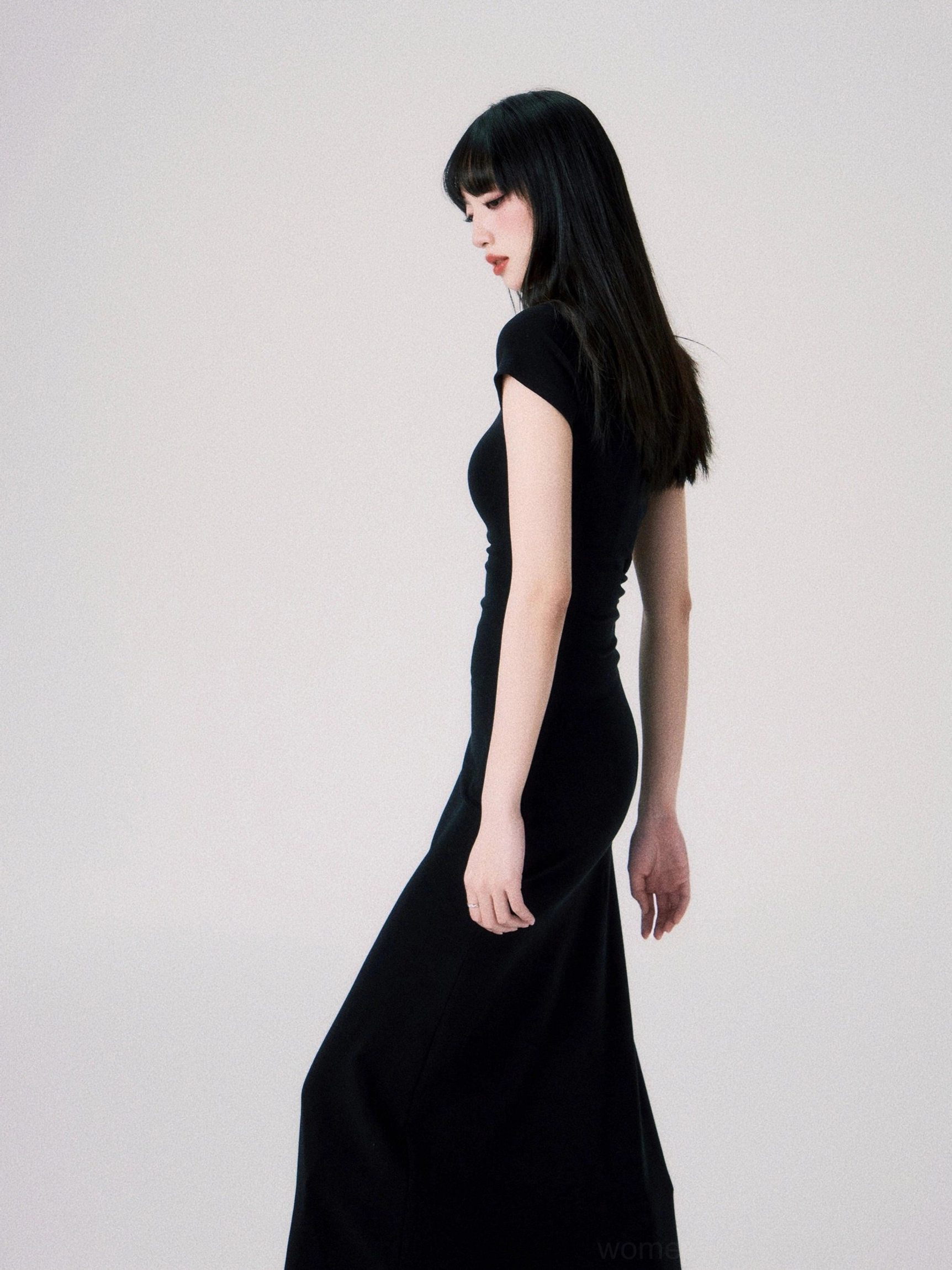 Elegant butterfly emblem maxi dress designed with stretch knit fabric mock neck and fishtail hem