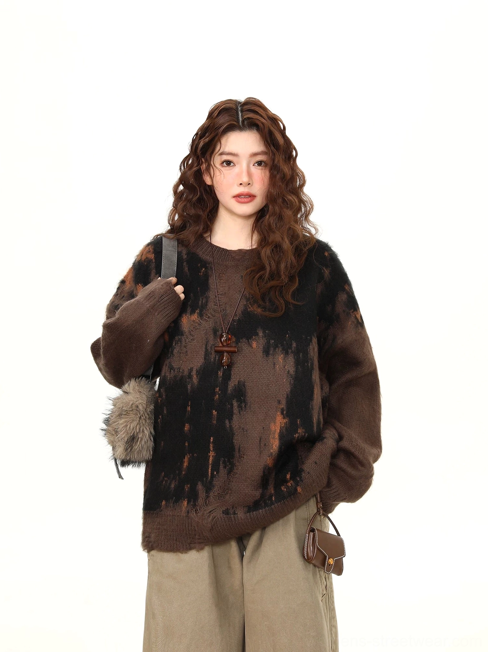 Close front view of oversized dark brown brushstroke crewneck knit sweater showing relaxed fit and ribbed neckline