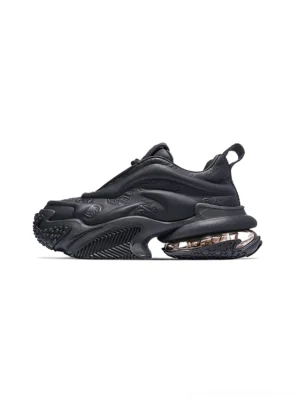 Black embossed platform chunky sneaker side view with sculptural upper transparent air cushion midsole ridged rubber outsole and heel pull tab