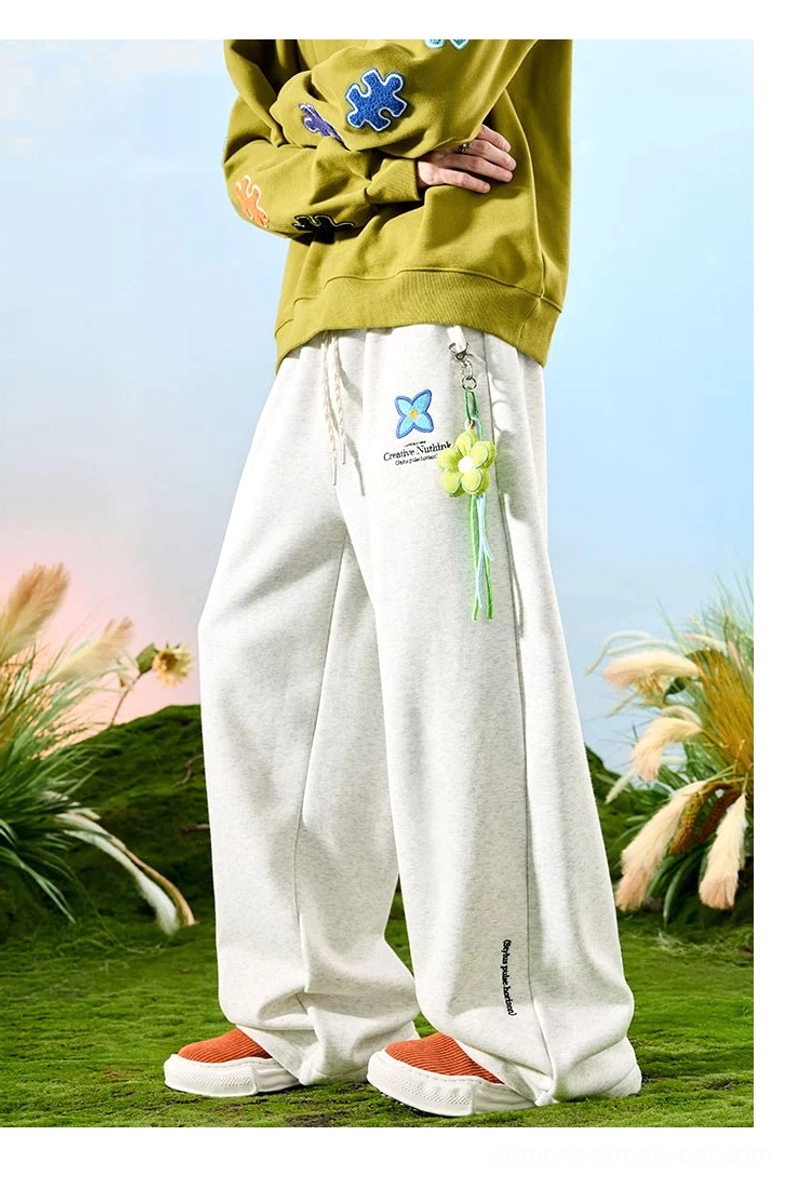 Embroidered floral wide-leg streetwear sweatpants with adjustable drawstring waist and colorful lower-leg details