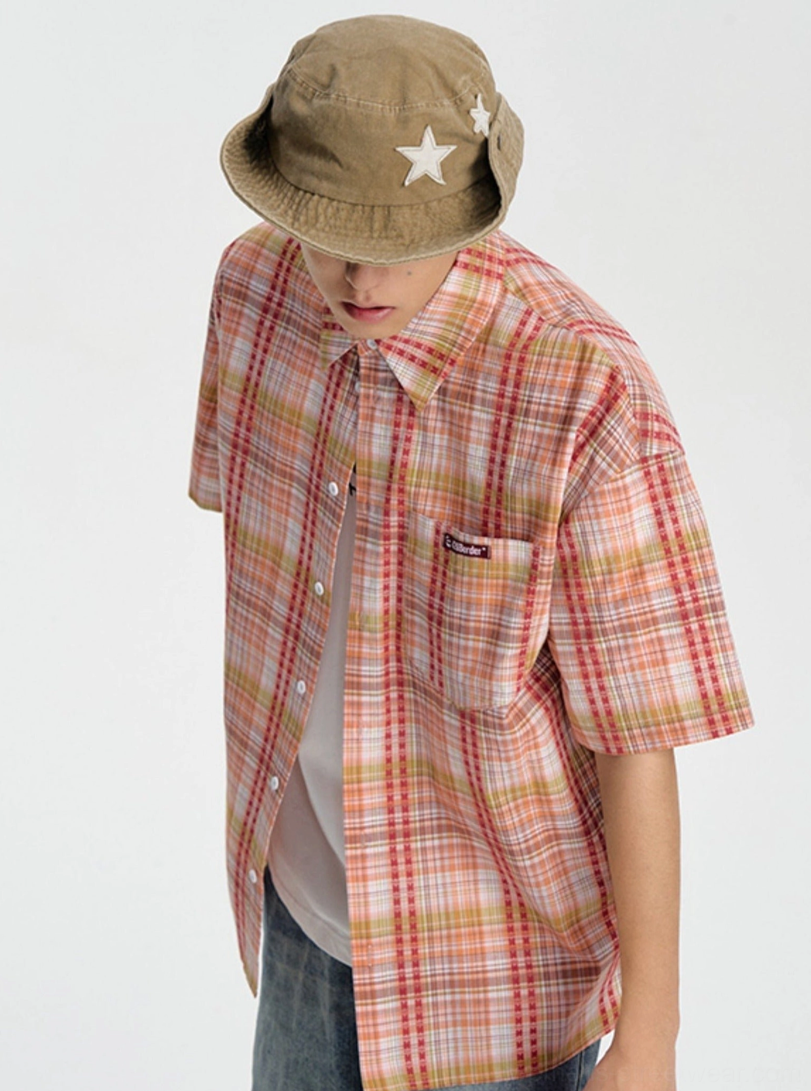 Embroidered plaid short sleeve shirt detail image highlighting the checkered streetwear pattern and relaxed button-down design