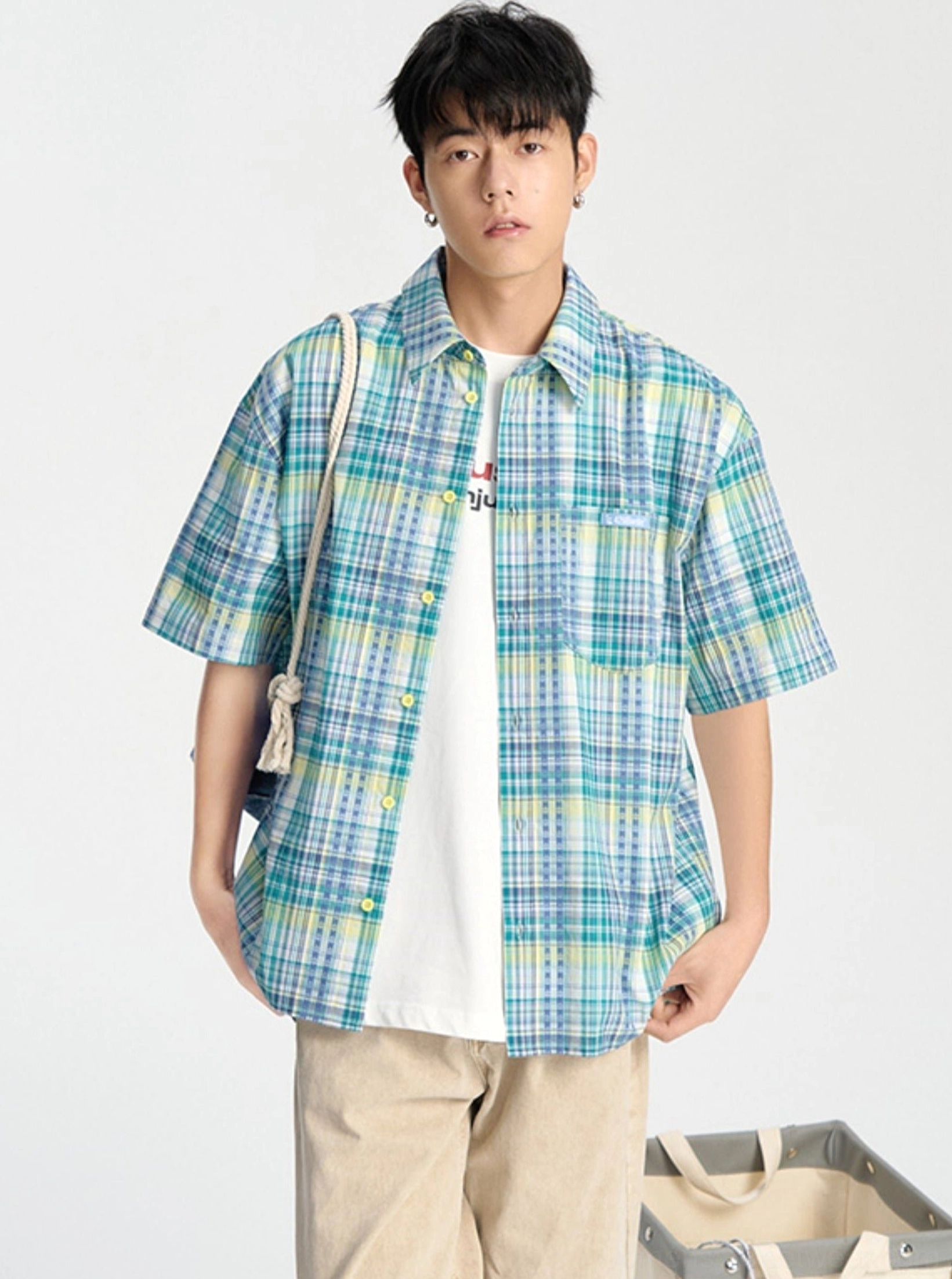 Blue embroidered plaid short sleeve shirt shown in a front full-body studio view with a relaxed Korean streetwear fit and white inner T-shirt