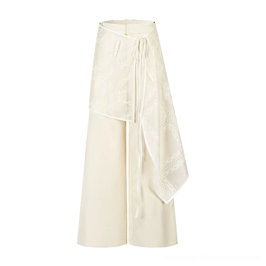 White embroidered wrap skirt wide-leg streetwear trousers with high-rise waist and fluid layered silhouette