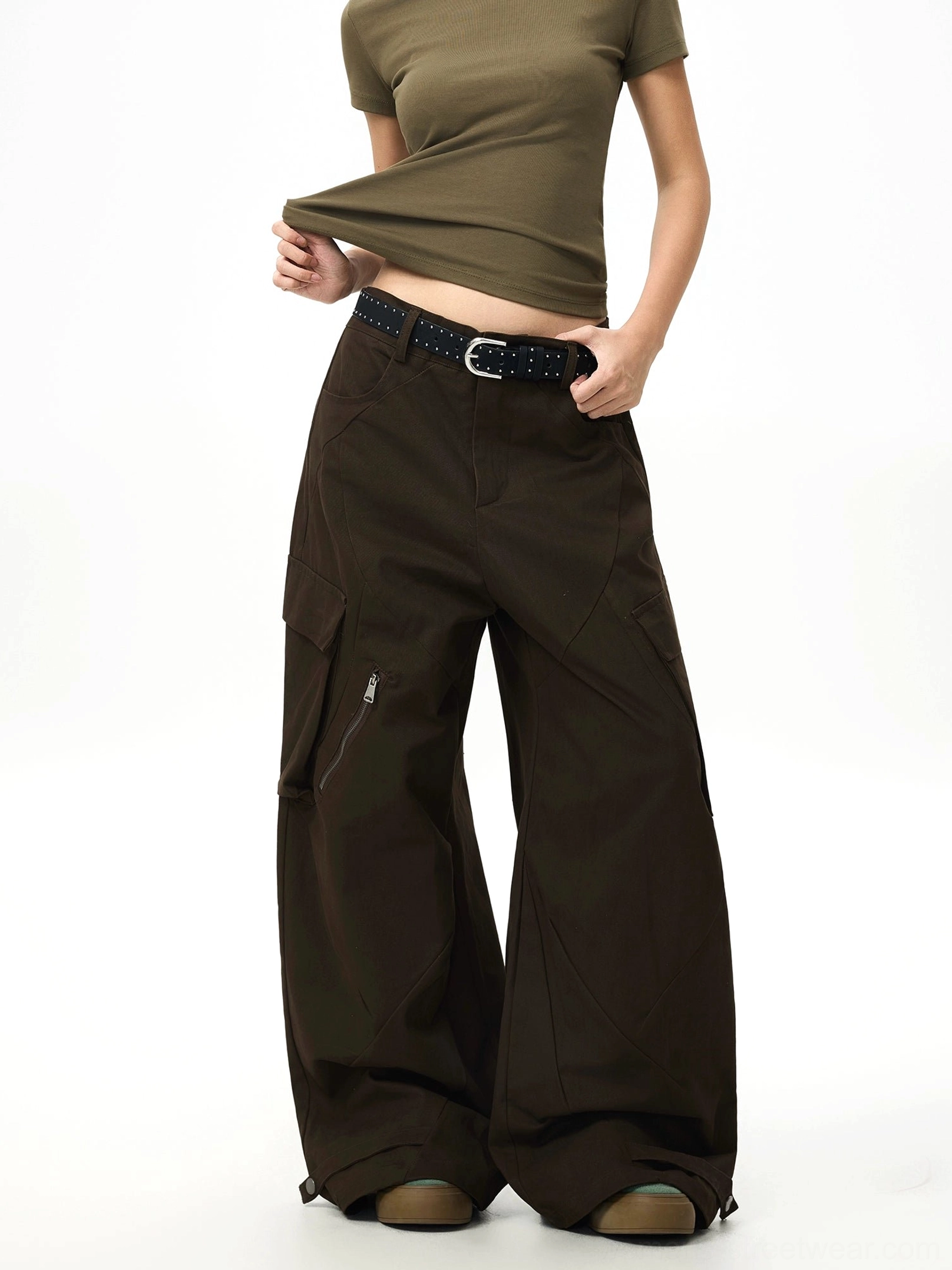 Side view of espresso brown parachute cargo pants showing zippered thigh pocket floor-grazing wide-leg fit and relaxed Korean streetwear silhouette
