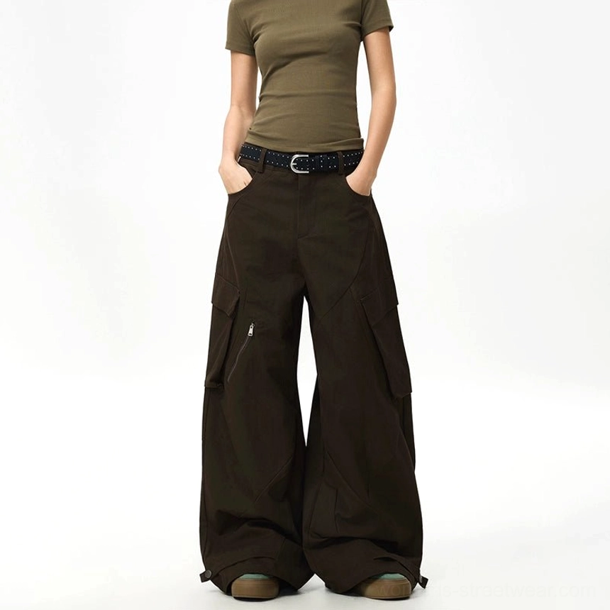 Front view of espresso brown streetwear cargo pants with oversized fit zippered thigh pocket adjustable cuffs and olive cropped top