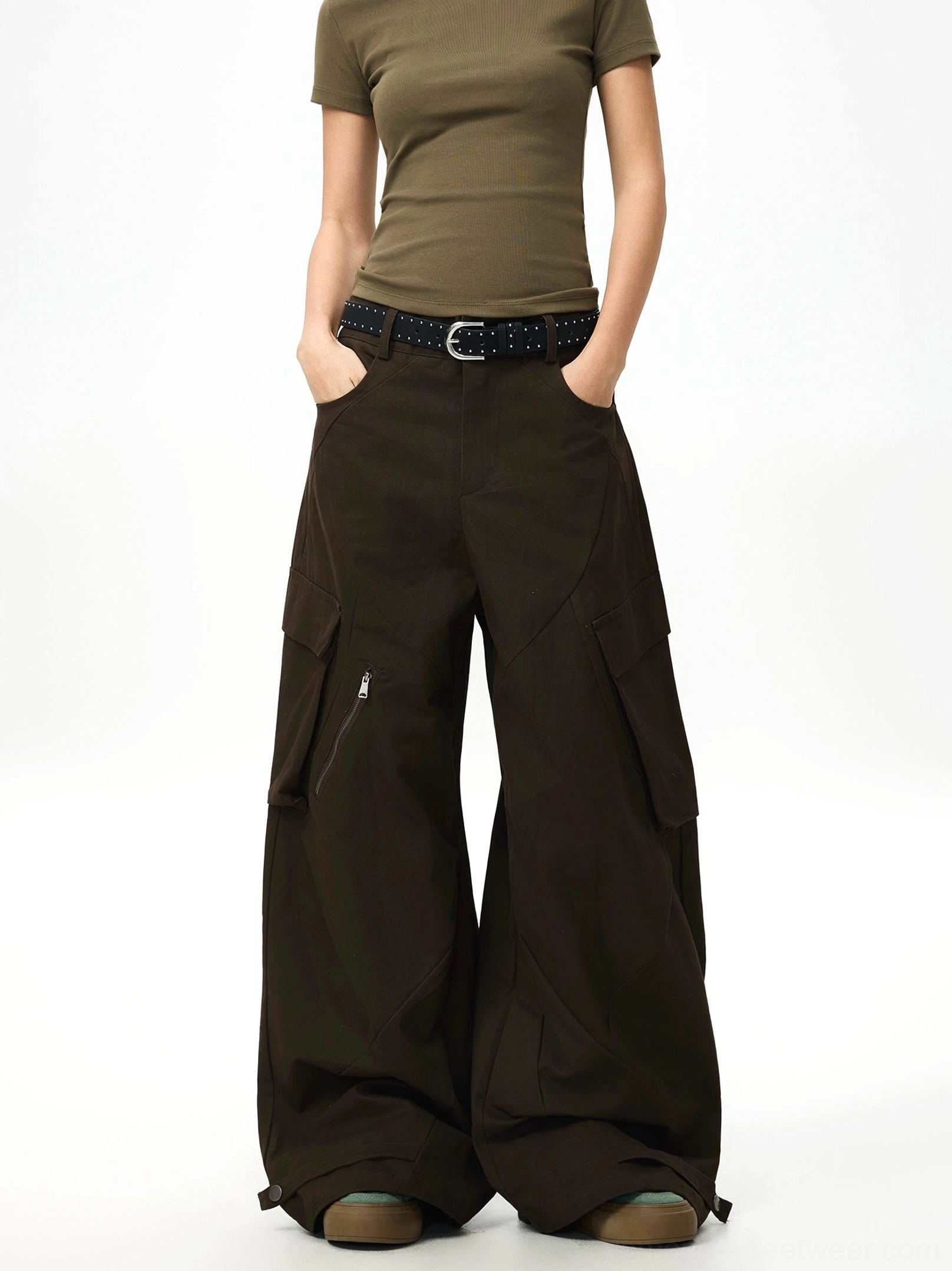 Front three-quarter view of espresso brown wide-leg streetwear cargo pants with oversized pockets adjustable ankle cuffs and olive cropped top