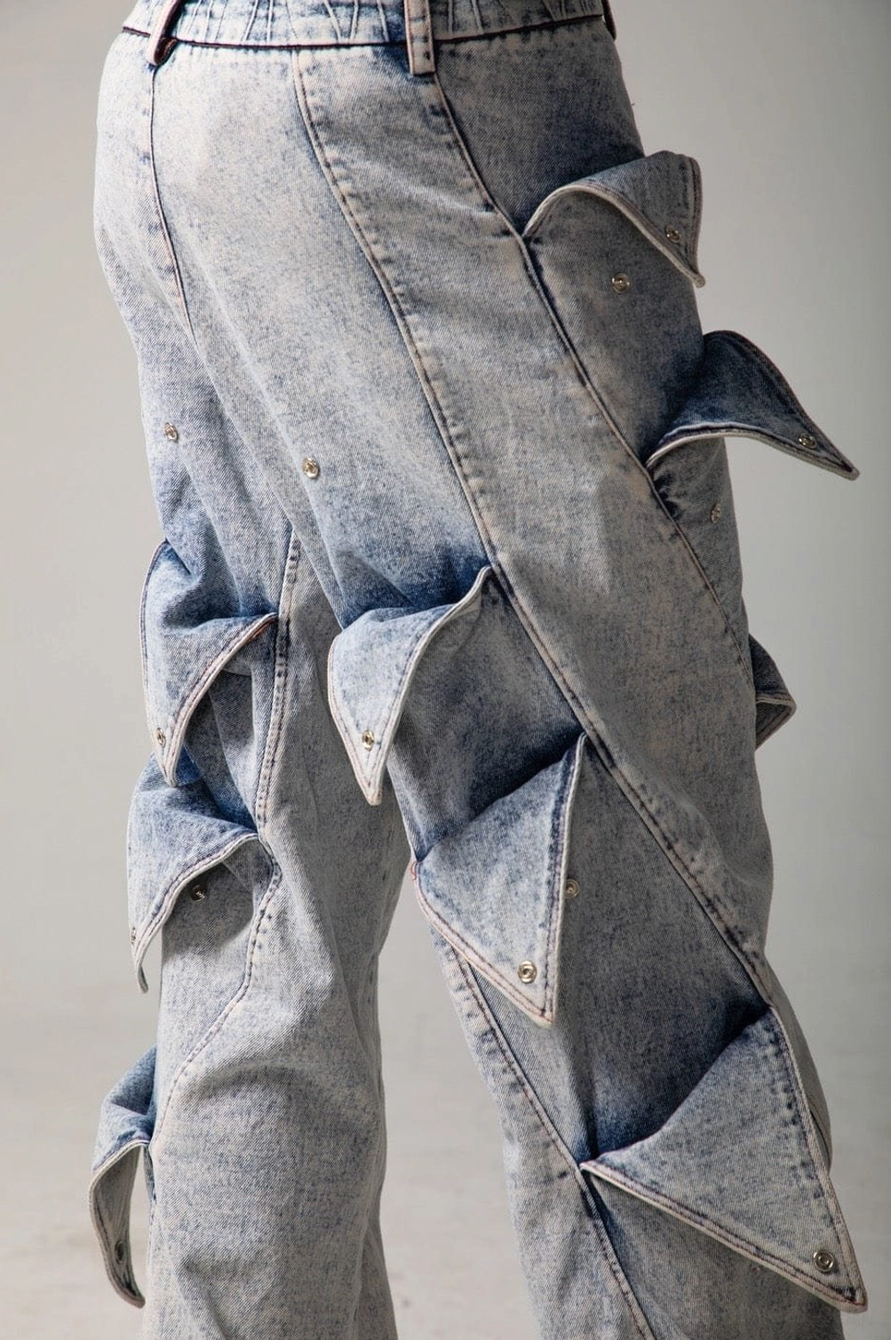 Faded acid wash shark fin panel jeans designed for oversized Y2K and avant-garde streetwear outfits