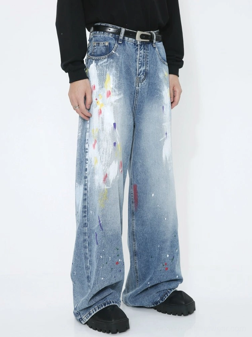 Faded blue avant-garde splash wide-leg jeans with colorful painted artwork, relaxed fit and full-length streetwear silhouette
