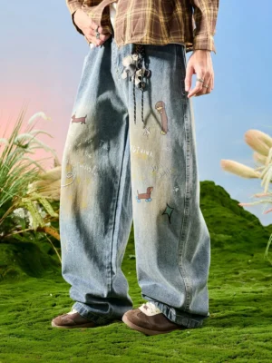 Three-quarter side view of playful doodle printed wide leg jeans in faded light blue denim with cute graphics and matching plush pendant