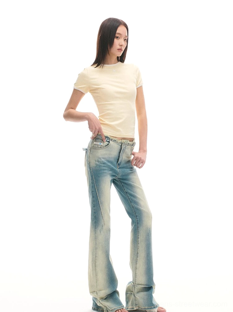 Faded blue low-rise vintage flared jeans shown from the side with a slim upper leg and wide flared hem