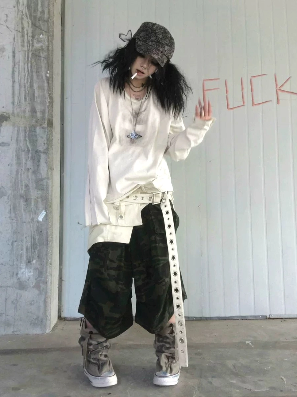 Oatmeal gray faded cross graphic long sleeve tee paired with camouflage wide-leg pants in a grunge streetwear outfit