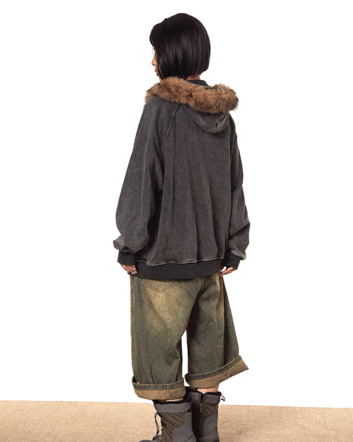 Back view of faded dark grey oversized faux fur hooded zip-up jacket with ribbed hem and relaxed vintage silhouette