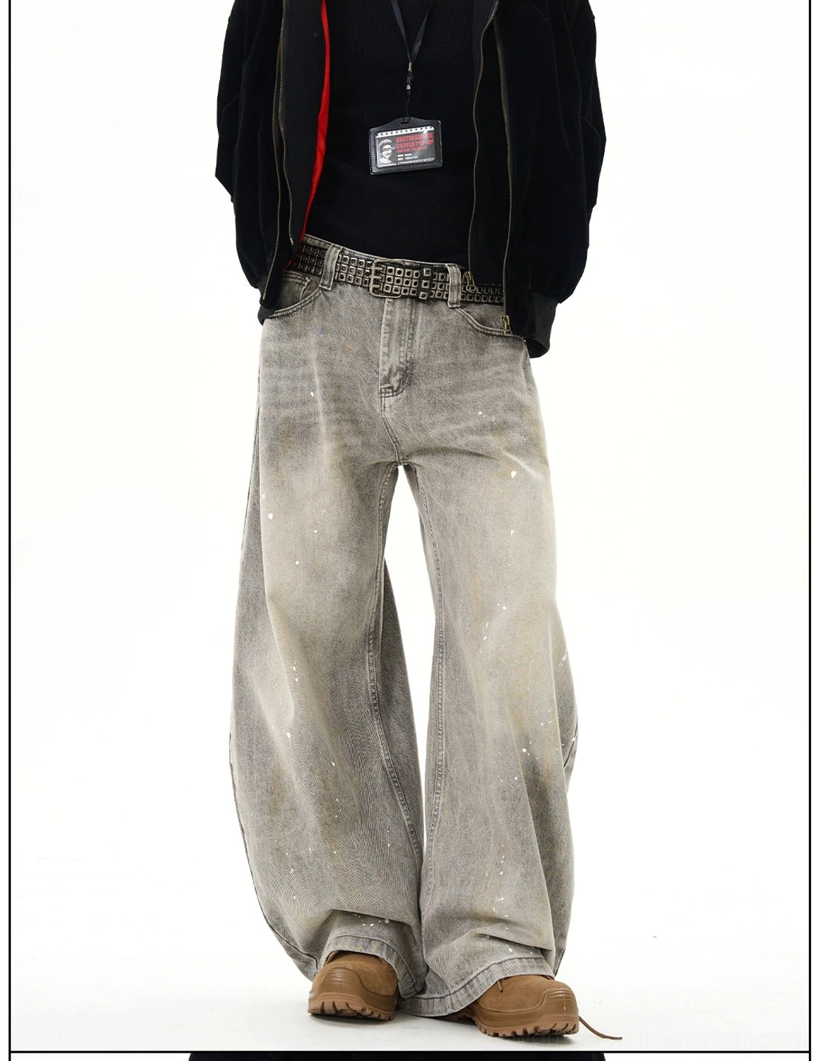 Close front detail of faded gray paint splatter wide leg jeans showing pockets waistband and denim texture