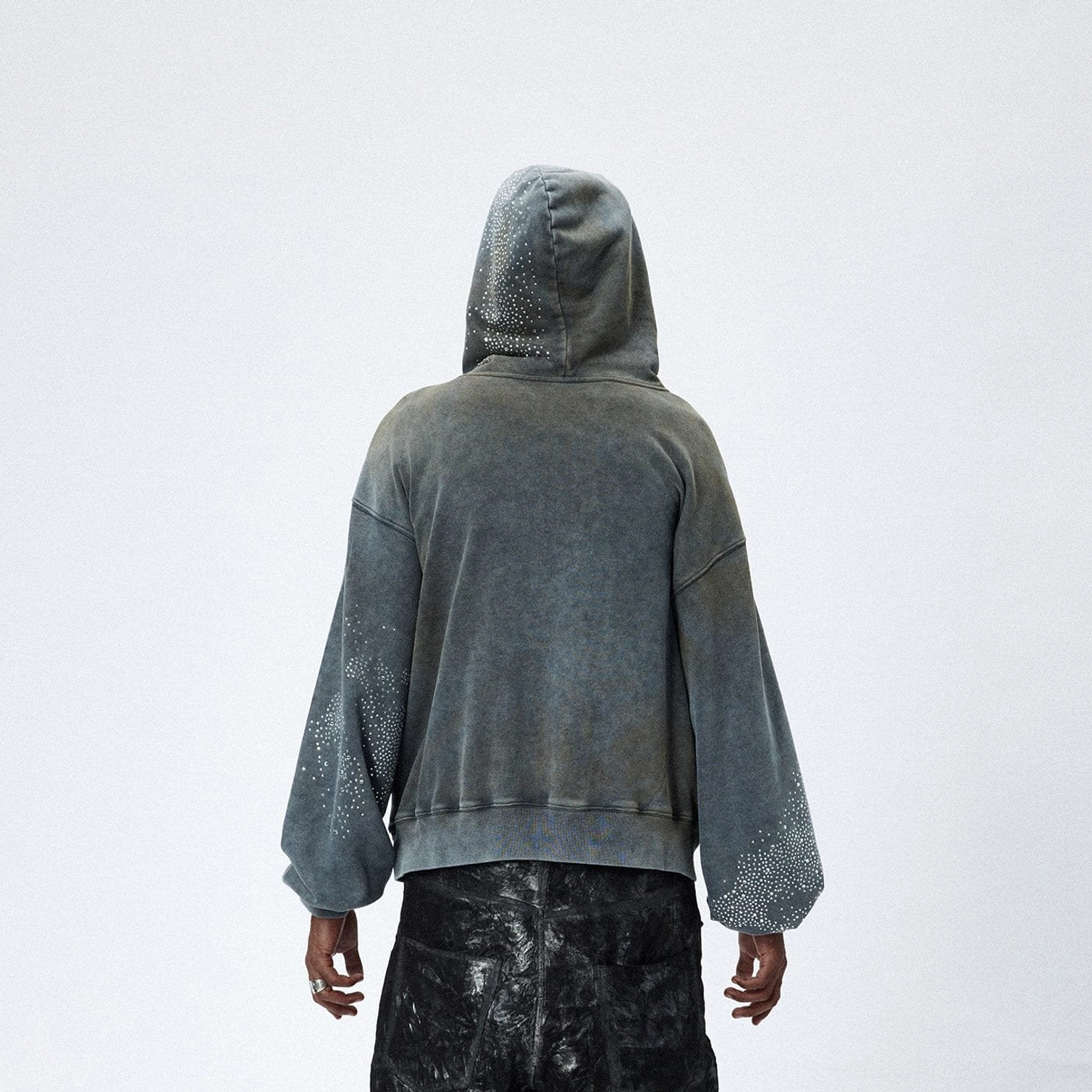 Back view of faded grey starlight crystal zip hoodie showing relaxed hood and vintage washed streetwear fabric