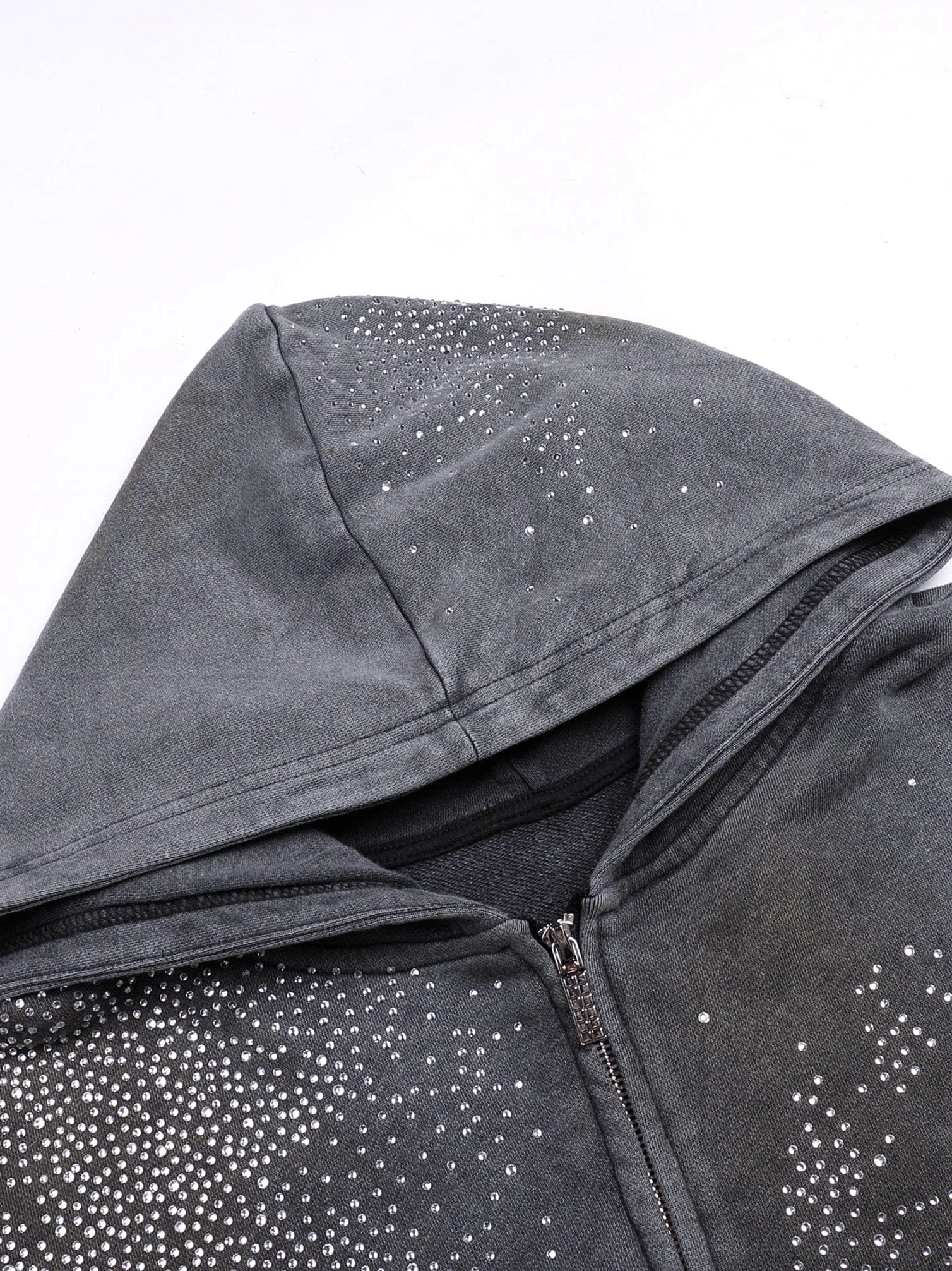 Close up of faded grey starlight crystal zip hoodie collar with metal zipper and star rhinestone decoration
