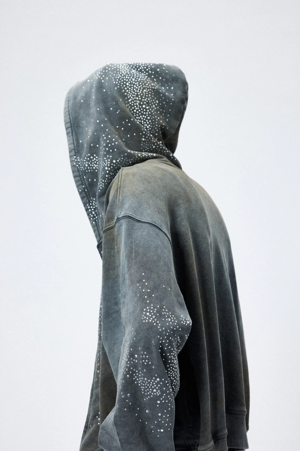 Rear side view of faded grey starlight crystal zip hoodie showing drop shoulders hood and washed cotton texture