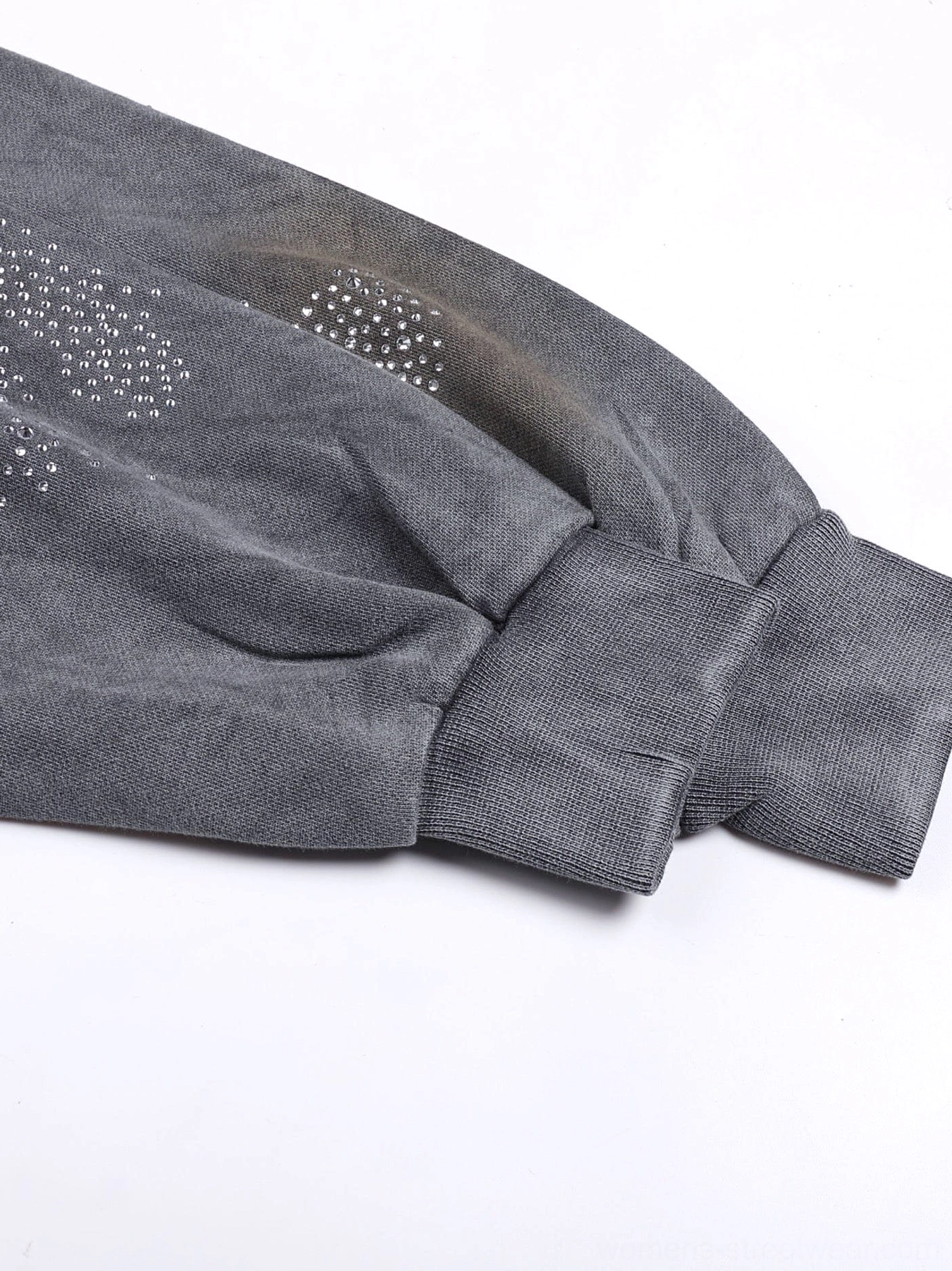 Detailed view of star shaped rhinestones and vintage washed fabric on the faded grey crystal zip hoodie