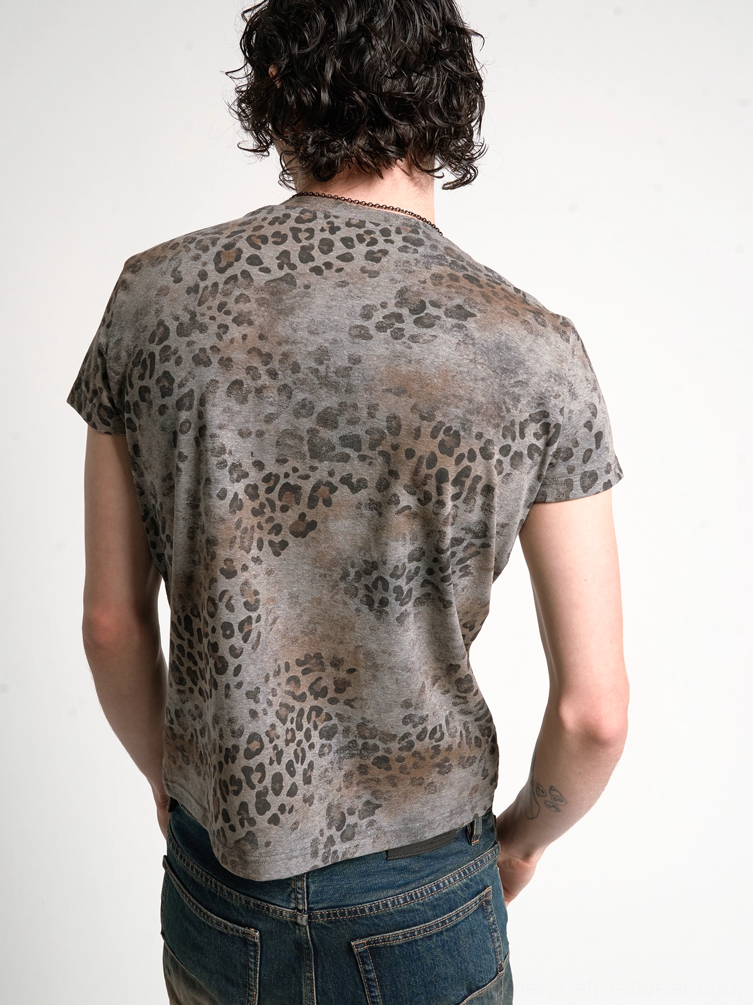 Rear full-body view of the leopard print short sleeve Henley tee showing the complete faded animal pattern