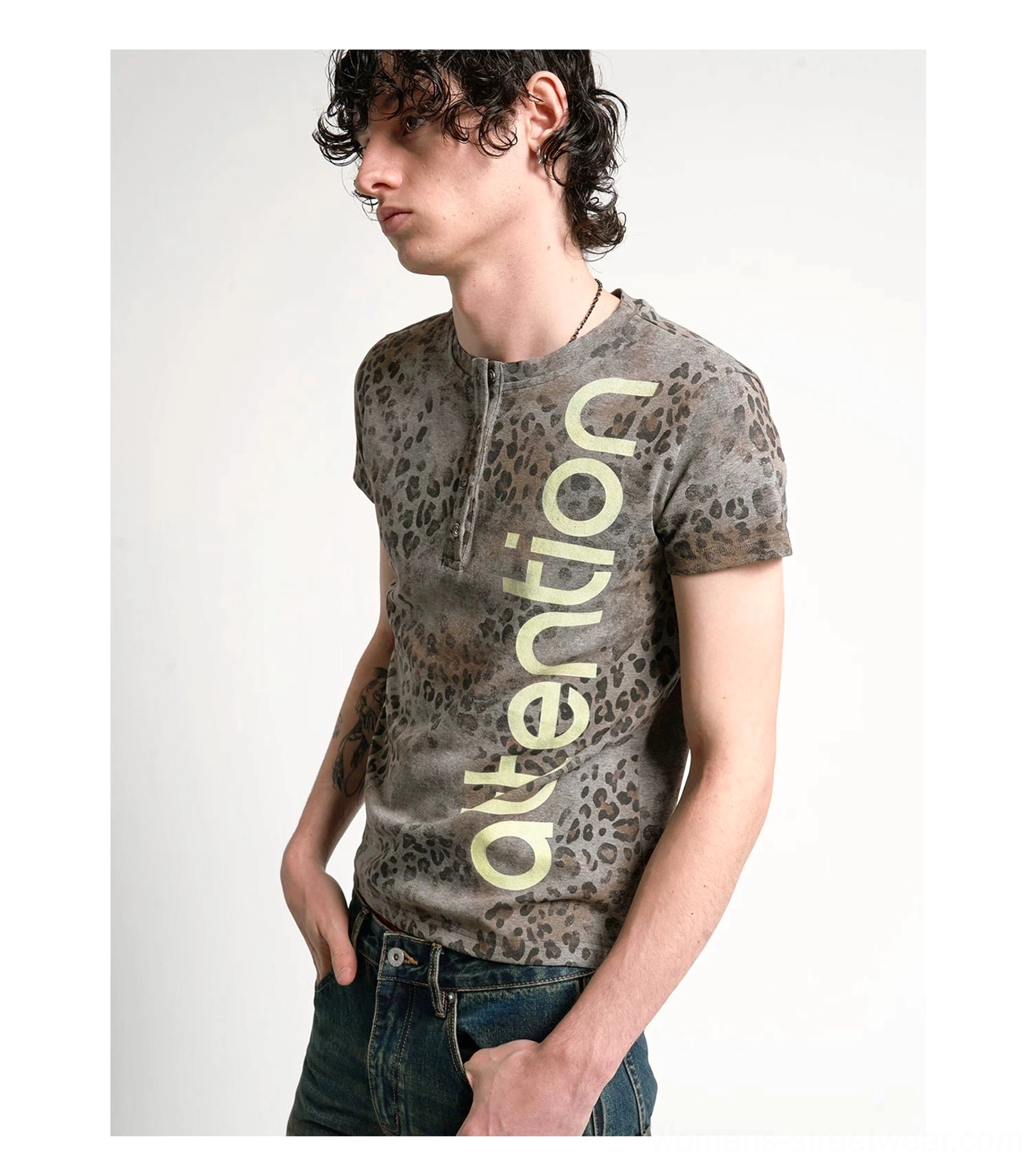 Side front profile of a faded leopard Henley tee with button placket, short sleeves, and vertical attention print