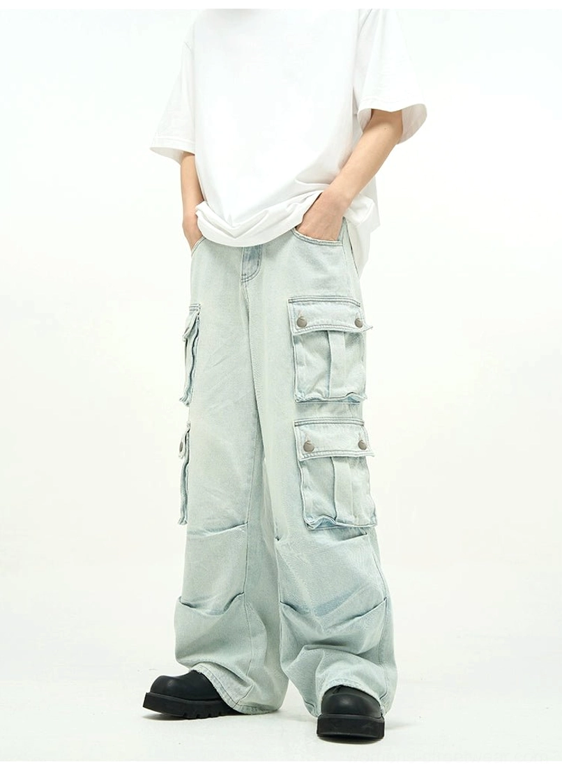 Front view of faded light blue baggy cargo jeans with double-row thigh flap pockets and extra-wide legs for utility-inspired streetwear styling