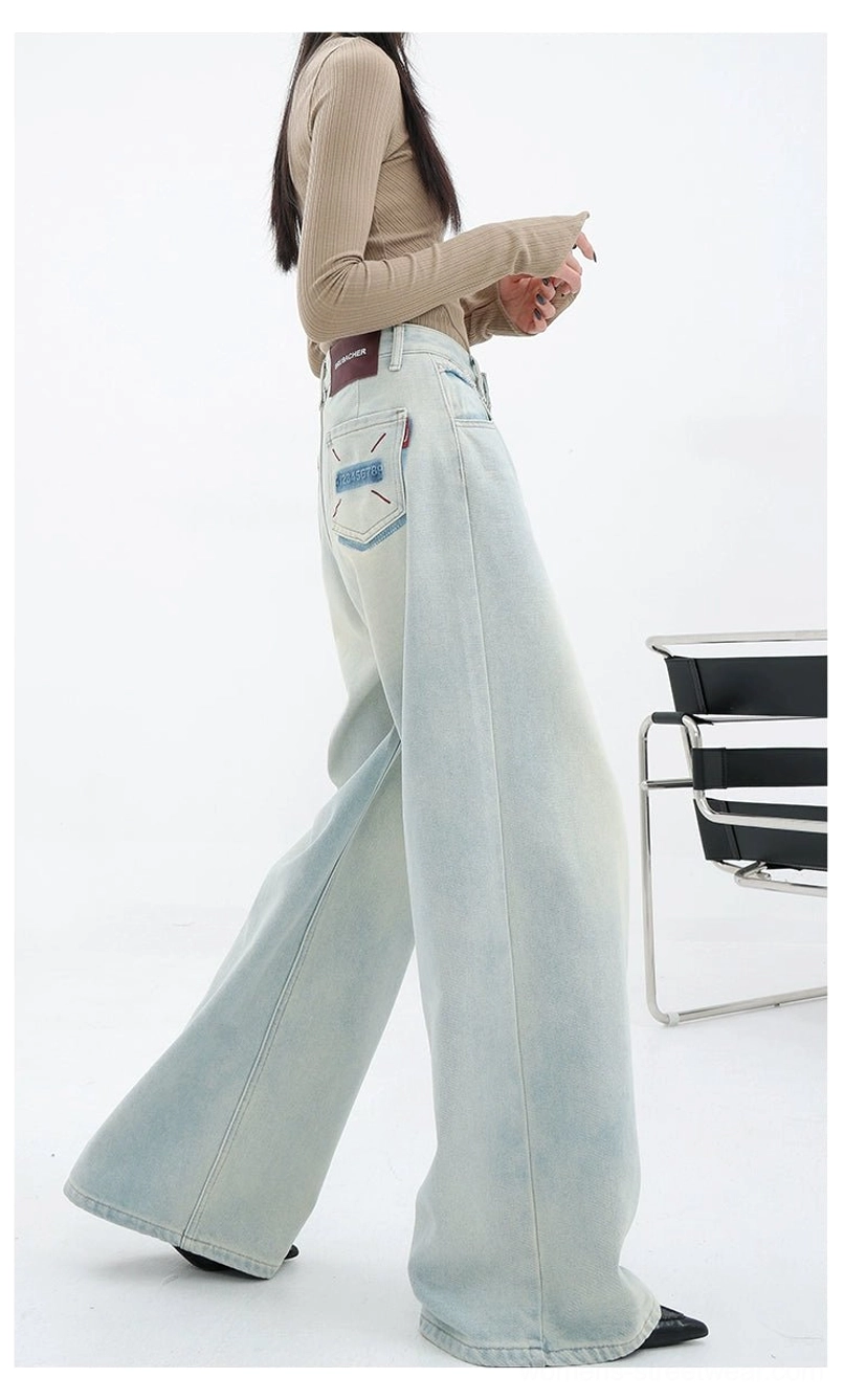 Faded light blue wide-leg denim pants with embroidered pocket detail for women’s urban streetwear outfits