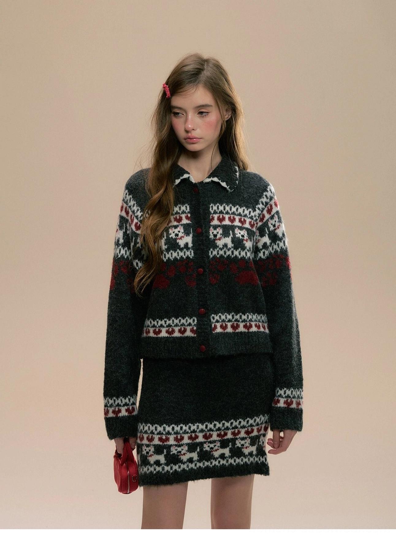 Three-quarter view of fuzzy Fair Isle knit cardigan and matching skirt with pointed collar, festive motifs, and wine-red details