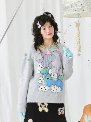 Front close-up of a silver-grey sparkle cartoon knit sweater with colorful graphic artwork, green shoulder studs, and relaxed Korean streetwear styling