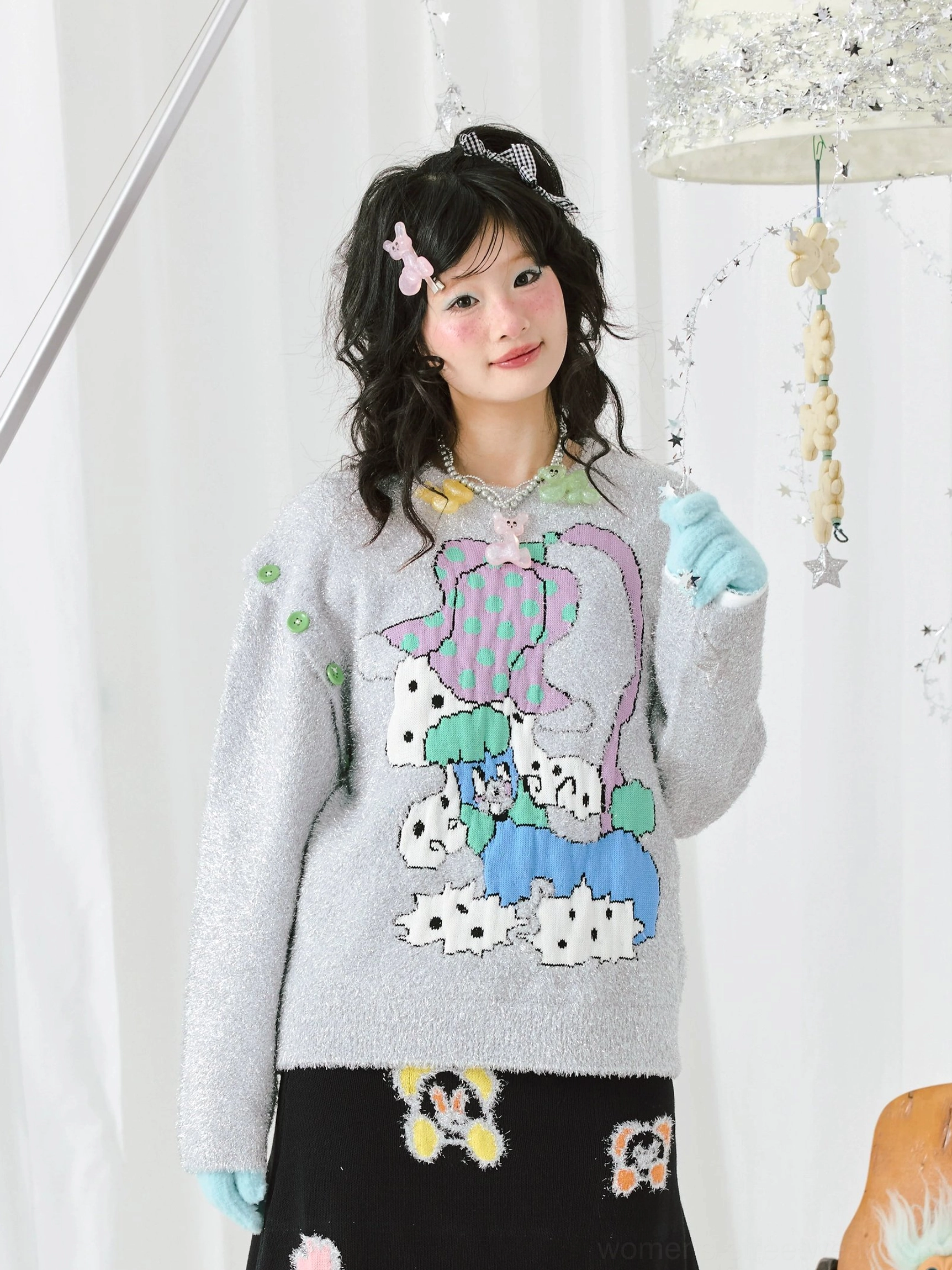 Front close-up of a silver-grey sparkle cartoon knit sweater with colorful graphic artwork, green shoulder studs, and relaxed Korean streetwear styling