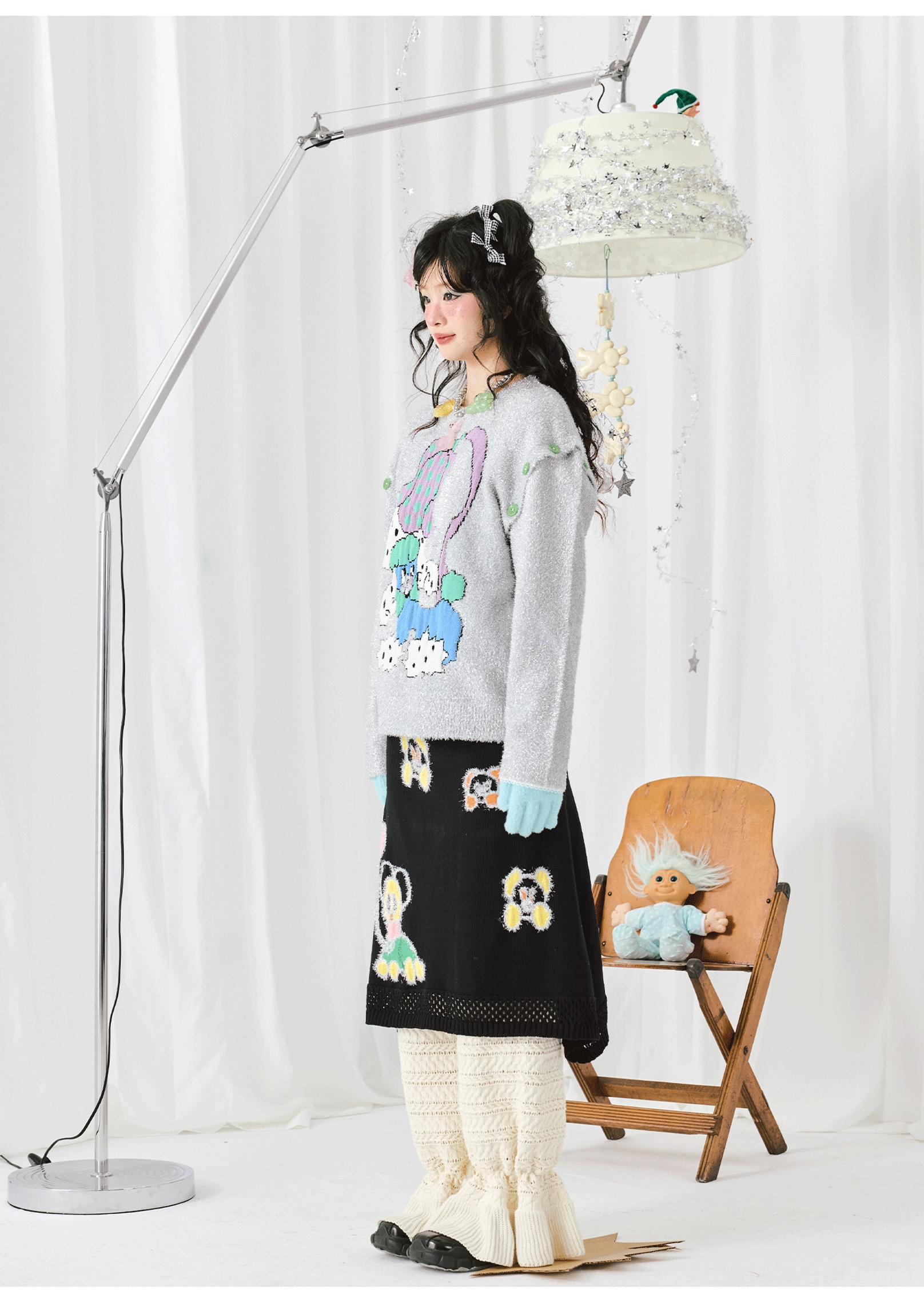 Side view of a loose silver-grey sparkle knit sweater with long sleeves styled in a dreamy Korean streetwear coordinate
