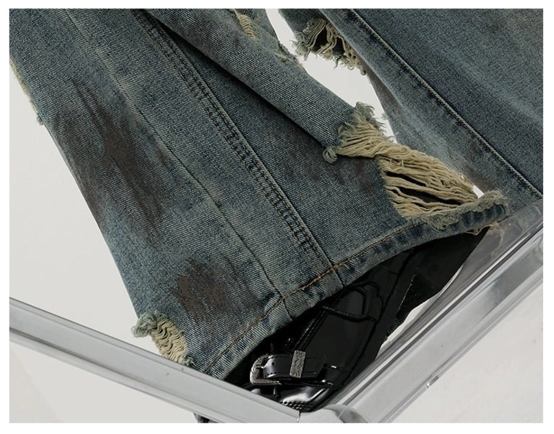 Fashion-forward washed blue wide-leg jeans with tie-dye-inspired variation and edgy distressed denim finish