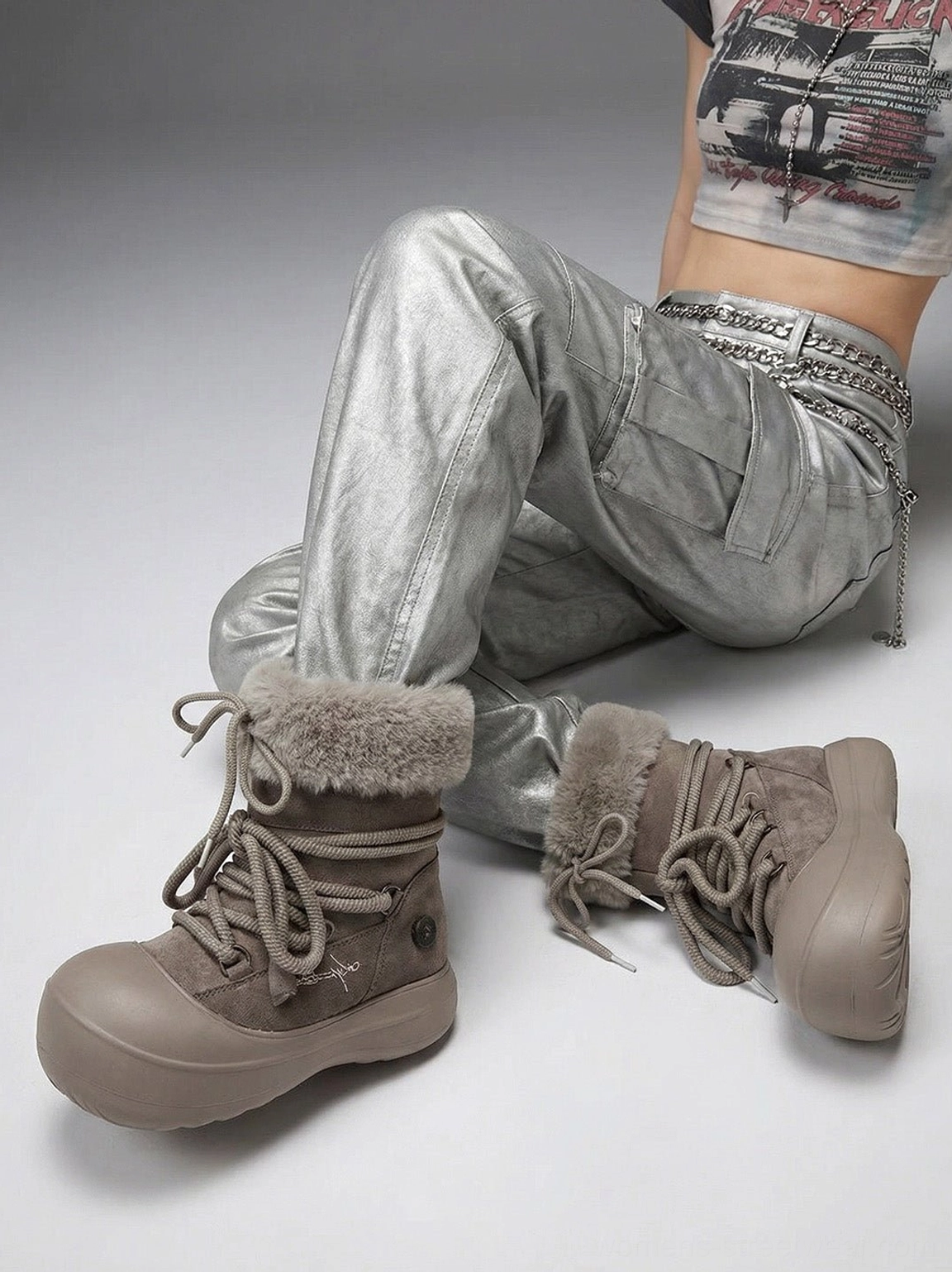 Low angle model view of taupe faux fur cuff platform snow boots with rounded chunky sole